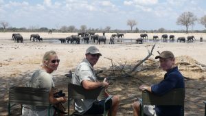 Mum , Dad and son enjying elephants at a waterhole and being Covid safe.
